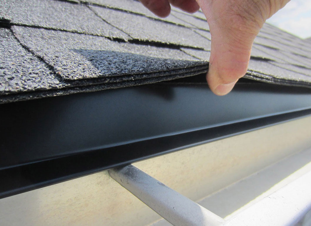 inspecting roof shingles