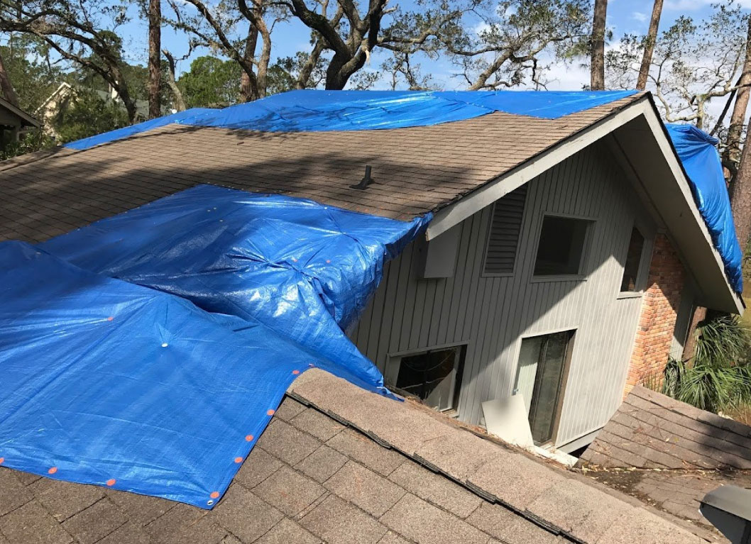 tarp across on damaged roof